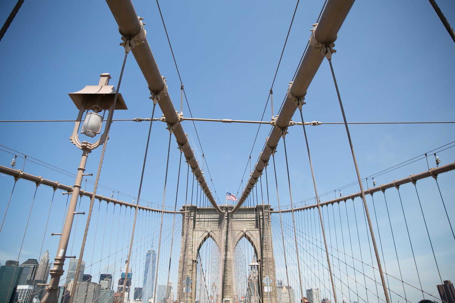 The Brooklyn Bridge silhouetted against a clear blue sky